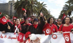 tunisia_women_wave_flags_during_a_march_to_celebrate_international_womens_day_in_tunis_on_march_8_2014